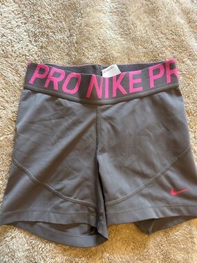 Nike Women's Gray Athletic Shorts with Pink Logo and Waistband